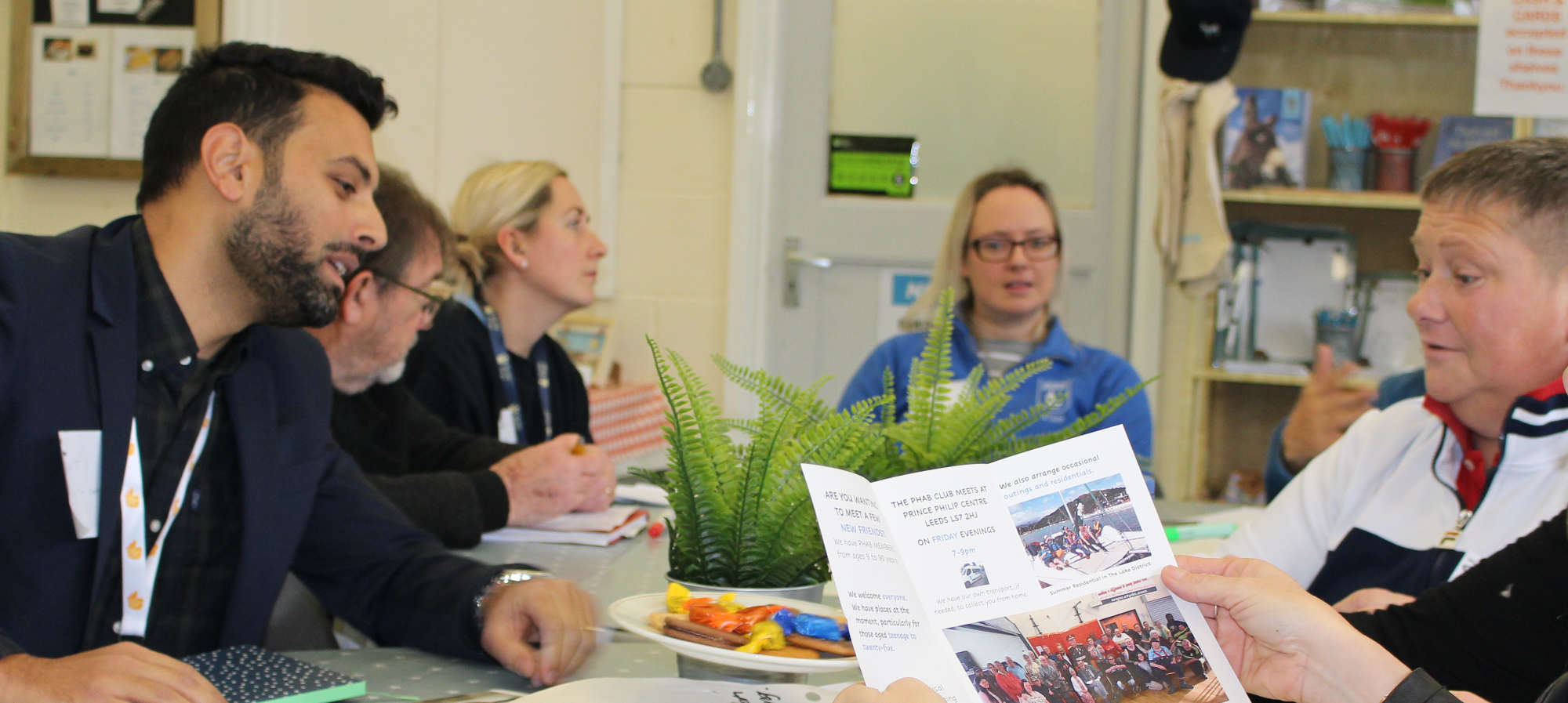 Image of a meetign at WYCANN where people are discussing events