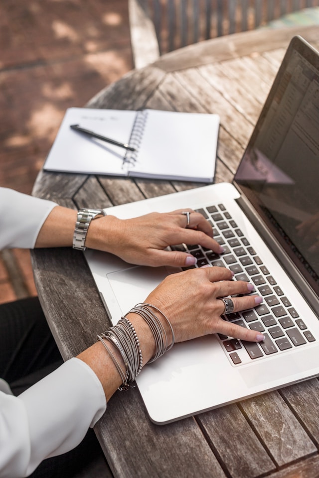 Image of a woman with a watch, bracelets and rings on typing on a laptop.
Photo by LinkedIn Sales Solutions on Unsplash