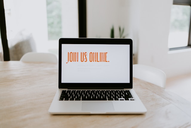 Image of a laptop open on a table. The screen is white except for orange text 'Join Us Online'
Photo by Samantha Borges on Unsplash